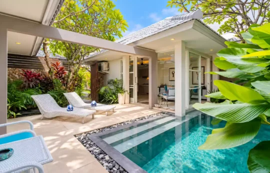 Swimming pool view of sunny day with villa exterior