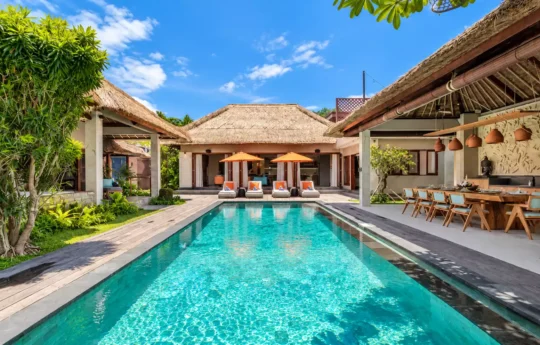 Swimming pool view of sunny day with villa exterior